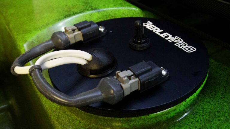 Introducing the BerleyPro Dimmer – the ultimate solution for customizing your lighting experience! This sleek, round green gadget comes with two sturdy gray cables and a convenient black switch on top. It's designed to seamlessly adjust your lighting with efficiency and ease, ensuring you get the perfect illumination every time. Experience the innovation and craftsmanship you've come to expect from BerleyPro!.