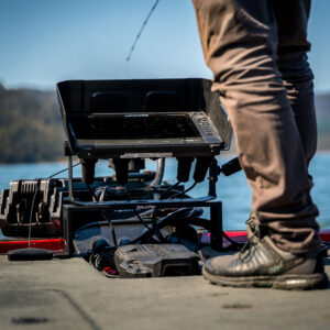 Meet the Bow Mount Bro, totally in his element! He's perched on the deck of his trusty boat, giving his gear a thorough once-over. The backdrop? Just an epic spread of serene lake waters and rolling hills. Classic day on the water!.