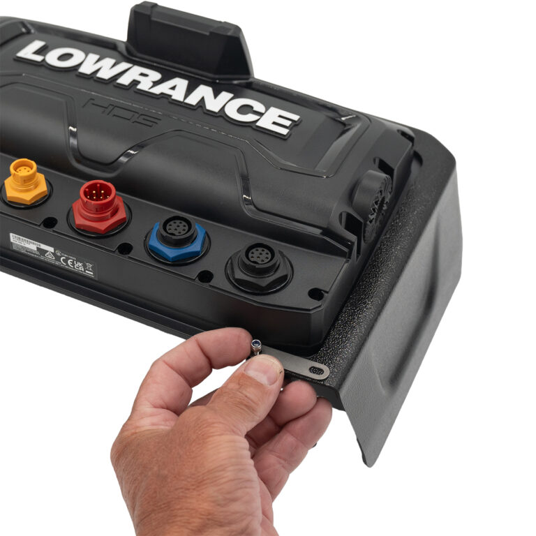 Check out this close-up shot: you're seeing someone expertly holding a tiny screw, right in the middle of assembling Lowrance Visors. Ports and connectors are all on display, shining like the stars of this show!.