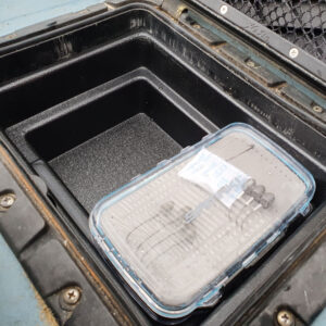 Slide your compact, clear plastic container snugly into the sleek black storage compartment of your ride, perfectly set for an adventure with the trusty Bucket Bro (Designed to Fit Hobie®).