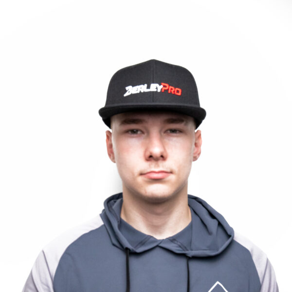 In true BerleyPro style, this individual stands confidently against a crisp white backdrop, rocking the iconic BerleyPro Cap. Paired perfectly with a hoodie, it's all about repping that signature logo with flair and attitude.