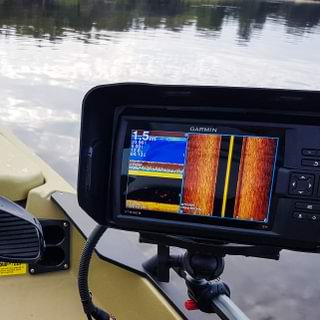 Picture this: you're out on the water, surrounded by the serene beauty of a peaceful lake, with towering trees lining the horizon. Your Garmin Visors fish finder monitor is your trusty sidekick, lighting up with crystal-clear sonar readings and turning your fishing expedition into an epic adventure.