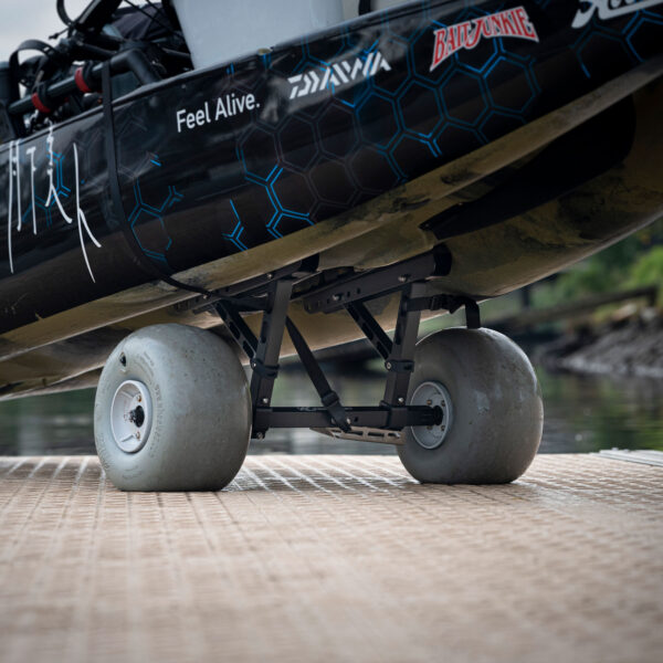 Check out this awesome shot of a boat rocking some big wheels down at the dock, flaunting those hexagonal patterns and stickers on its side. It's got that slick look reminiscent of the Kimmi Cart - Kayak Trolley, designed to slide you into adventure effortlessly.