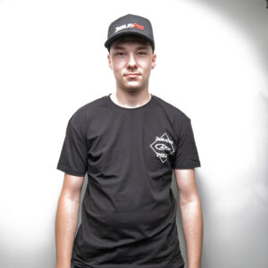 A legend steps into the spotlight, rocking the sleek BerleyPro Yipaah Express black T-shirt and matching cap. Against a crisp, clean white backdrop, this look is all about making a statement without saying a word.