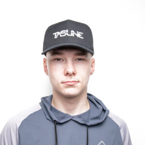With the stealth of a seasoned angler, this individual dons our Black Tasline Cap with its perfectly crafted Curved Bill, offering shade and style in equal measure. Complementing the cap is a cozy gray and dark blue hoodie that wraps them in comfort like calm waters embrace a kayak. Standing against a stark white backdrop, they’re ready to conquer whatever the day holds—whether it’s casting lines or casually making waves.