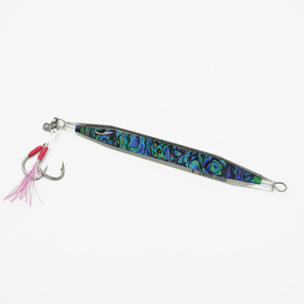 Reel in the ultimate catch with the Catch Double Trouble Paua Power Jig! Featuring a vibrant, multicolored abalone shell design, this jig is paired with a striking red and pink feathered treble hook, ready to make waves and turn heads on your next fishing adventure.