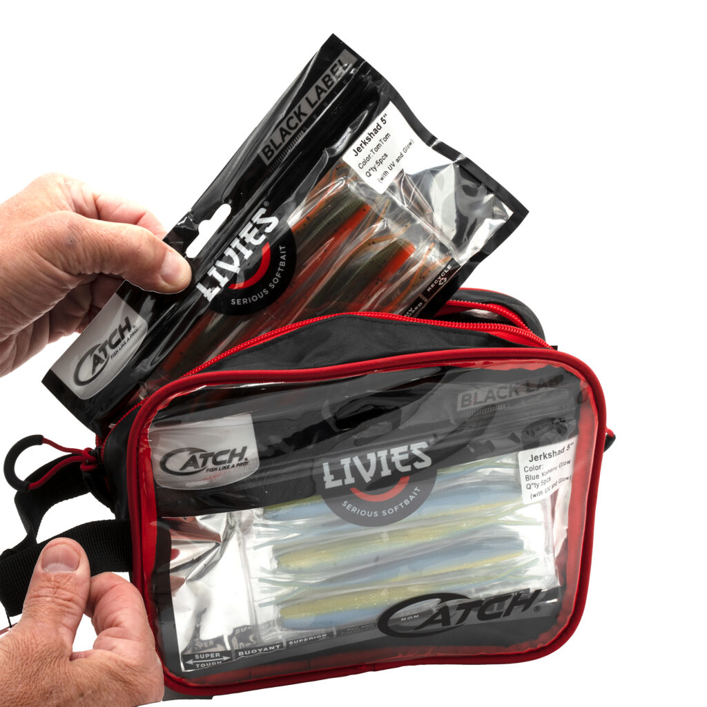 Picture this: hands eagerly clutching a "Jerkshad" lure pack, perfectly showcased against our crisp, clear Catch Softbait Storage Bag. This sleek red and black tackle bag isn't just eye candy—it's your ultimate sidekick for reeling in that next big trophy. Everything neatly organized and ready to roll whenever you are!.